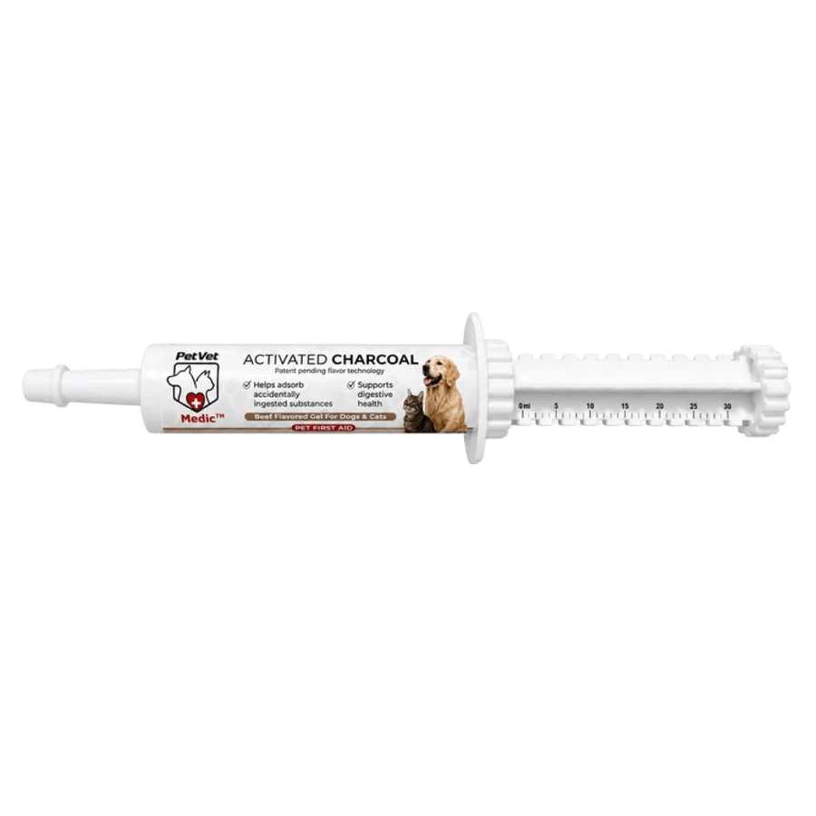 A white PetVet Medic activated charcoal oral syringe for dogs and cats displays measurement markings and a label featuring a dog and cat.