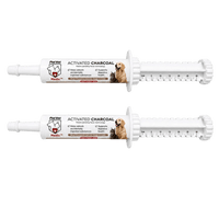 Two white PetVet activated charcoal syringes for dogs and cats lie horizontally against a white background.