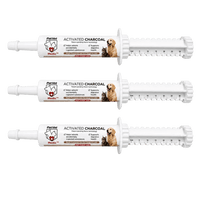 Three white PetVet Medic activated charcoal pet first aid gel syringes sit horizontally, featuring dosage measurement markings and images of a dog and cat on their labels.